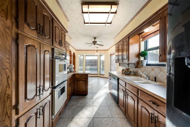 kitchen with tasteful backsplash, black fridge with ice dispenser, dishwasher, a textured ceiling, and sink