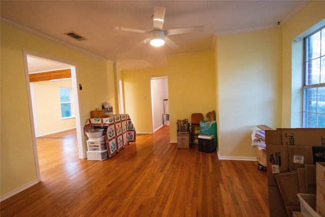 interior space with ornamental molding, hardwood / wood-style floors, and ceiling fan