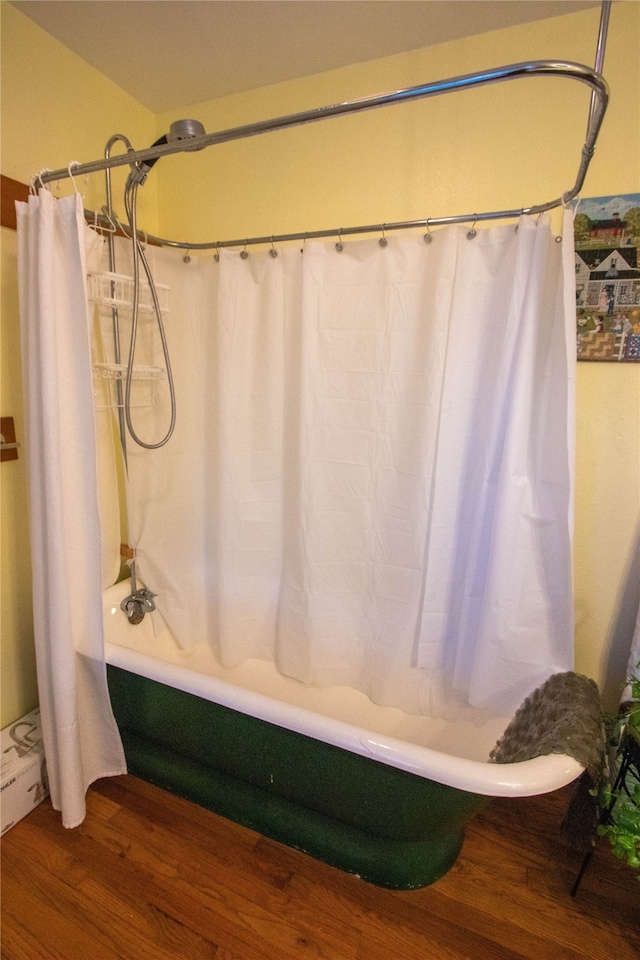 bathroom featuring shower / bath combination with curtain and hardwood / wood-style flooring