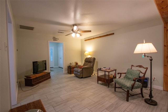 living area with ceiling fan