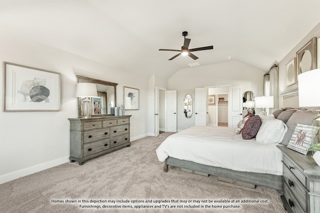 bedroom with a spacious closet, vaulted ceiling, ceiling fan, and light colored carpet