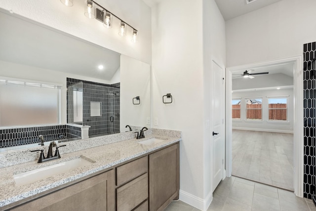 full bath with vaulted ceiling, a sink, and a shower stall