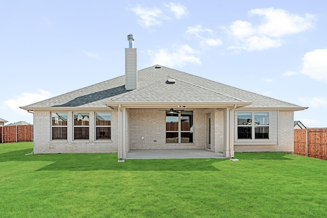 rear view of property with a yard, brick siding, a patio, and a fenced backyard