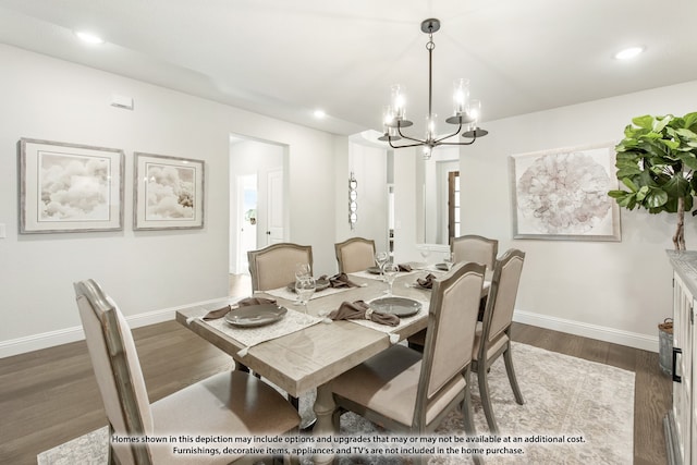 dining room with an inviting chandelier and dark hardwood / wood-style flooring