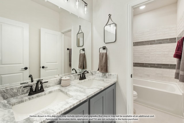 bathroom featuring vanity, toilet, and a tub