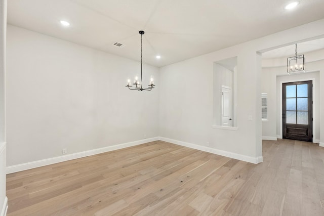 unfurnished dining area with baseboards, light wood-style floors, recessed lighting, and an inviting chandelier