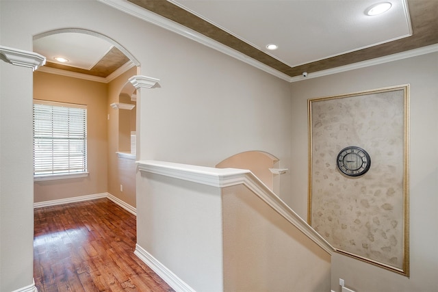 hall with hardwood / wood-style flooring and ornamental molding