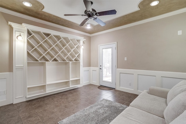 interior space featuring ornamental molding and ceiling fan