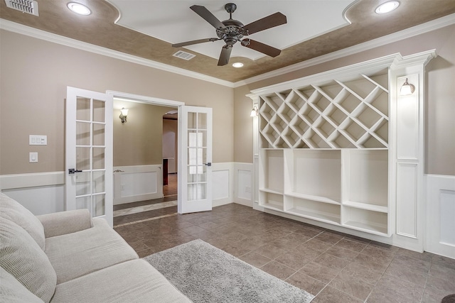 living room featuring ornamental molding, ceiling fan, and french doors