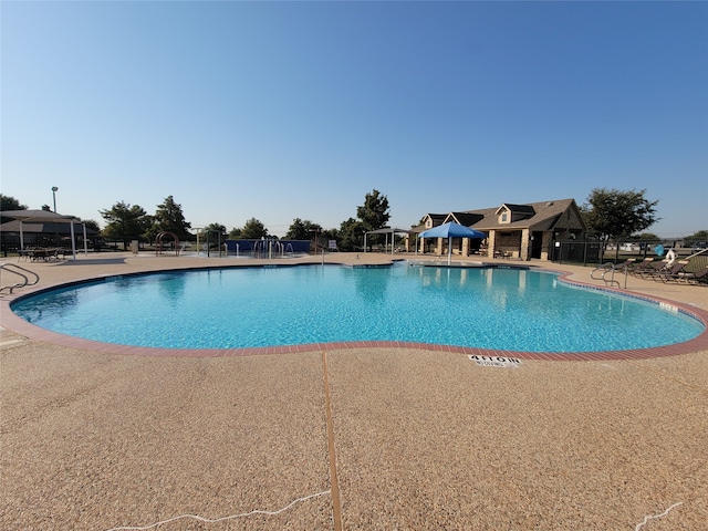 view of swimming pool with a patio area