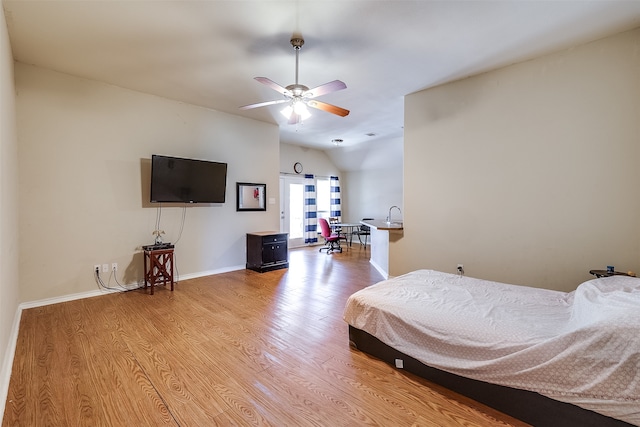 bedroom featuring light wood-type flooring, ceiling fan, and vaulted ceiling