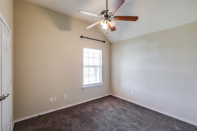 carpeted spare room featuring ceiling fan and vaulted ceiling