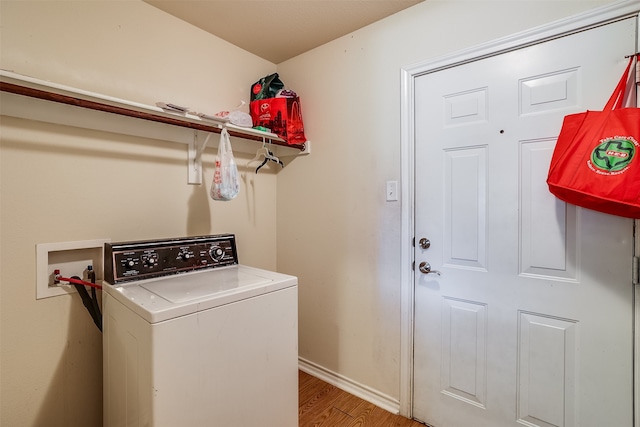 laundry room with light wood-type flooring and washer / dryer