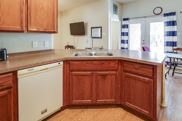 kitchen with kitchen peninsula, sink, light hardwood / wood-style floors, and dishwasher