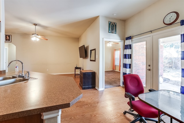 kitchen featuring ceiling fan, lofted ceiling, hardwood / wood-style floors, and sink