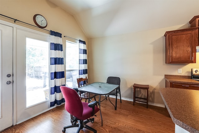 office space featuring lofted ceiling and hardwood / wood-style floors