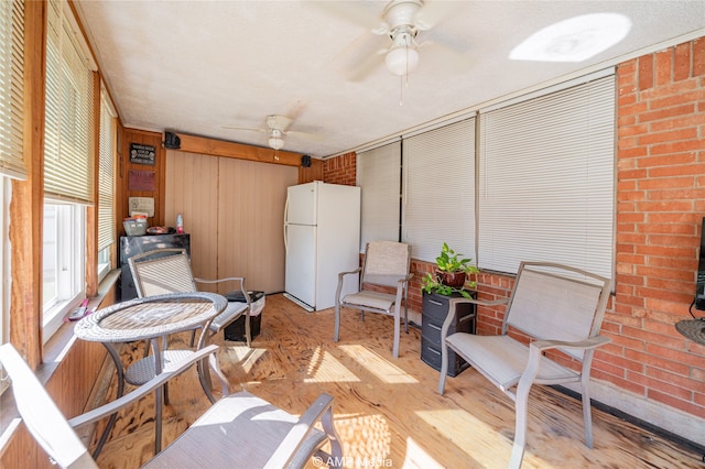 sunroom / solarium featuring ceiling fan