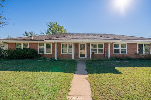 ranch-style home with a front lawn