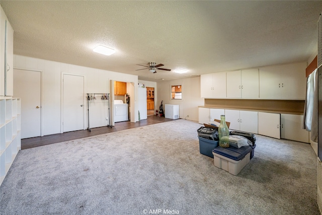 interior space with ceiling fan, washer / clothes dryer, and a textured ceiling