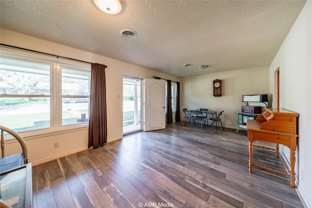 entryway with dark hardwood / wood-style flooring and a textured ceiling