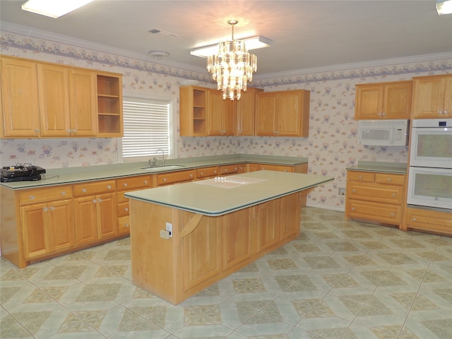 kitchen featuring a kitchen island, sink, white appliances, and ornamental molding