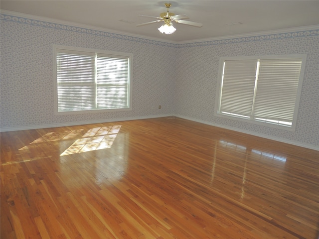 unfurnished room featuring ceiling fan, ornamental molding, and hardwood / wood-style flooring