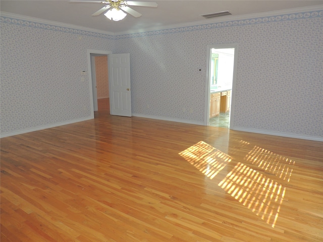 spare room with hardwood / wood-style flooring, ceiling fan, and ornamental molding