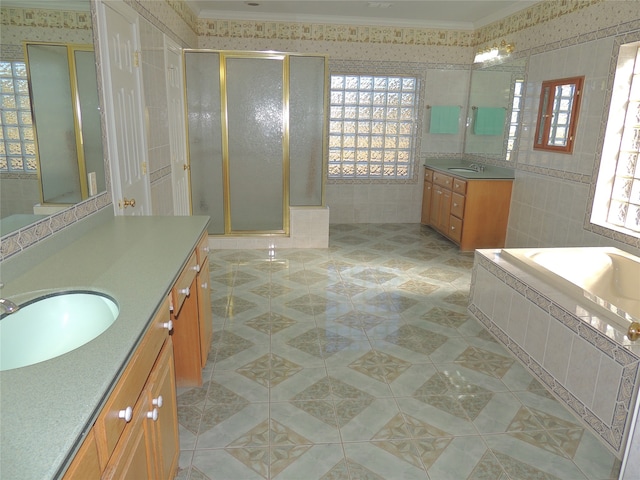 bathroom featuring tile patterned floors, vanity, separate shower and tub, and ornamental molding