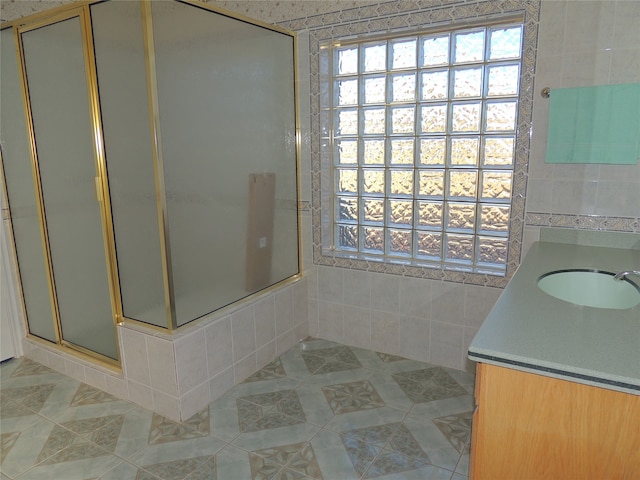 bathroom featuring tile patterned floors, vanity, and a shower with shower door