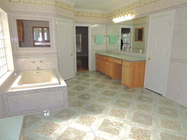 bathroom featuring vanity, tiled bath, and crown molding