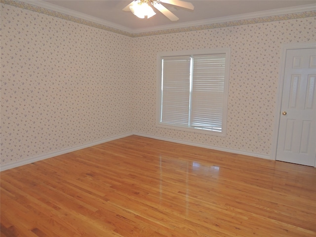 empty room with ceiling fan, light hardwood / wood-style flooring, and ornamental molding