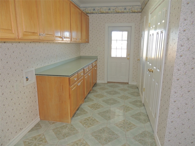 kitchen featuring light tile patterned floors and ornamental molding