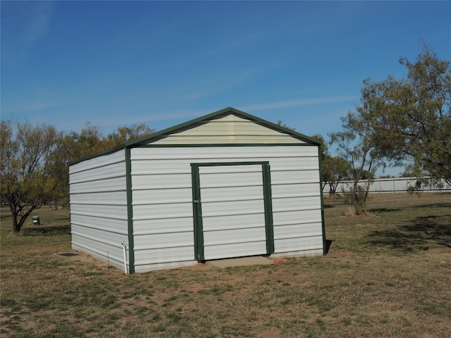 view of outbuilding featuring a yard