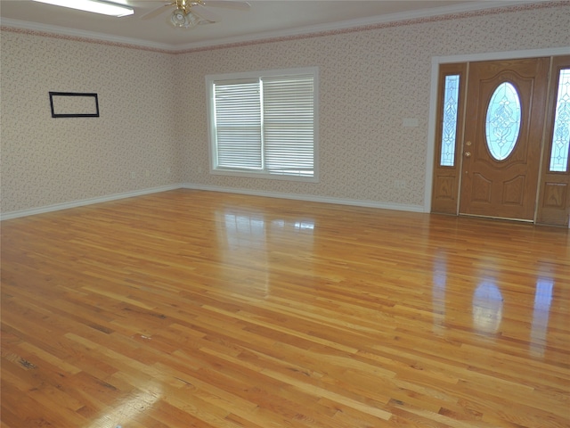 entrance foyer with light wood-type flooring, ceiling fan, and ornamental molding