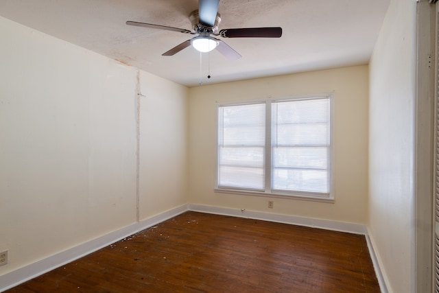 empty room featuring ceiling fan and dark hardwood / wood-style flooring