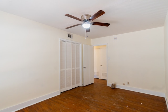 unfurnished bedroom featuring ceiling fan and dark wood-type flooring