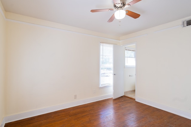 spare room with ceiling fan and dark wood-type flooring