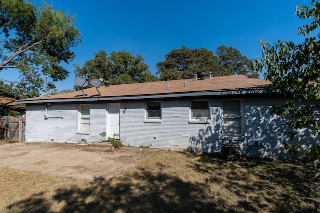 rear view of house with a yard