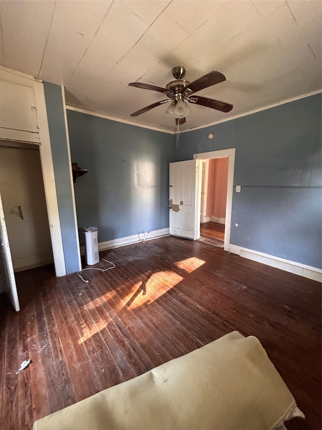 unfurnished bedroom with ceiling fan, crown molding, and dark hardwood / wood-style floors