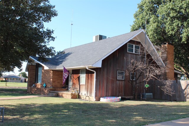 681 S 11th Ave, Munday, TX 76371 - view of front facade with a front lawn and central AC