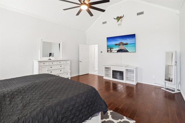 bedroom with ceiling fan, dark wood-type flooring, crown molding, and high vaulted ceiling