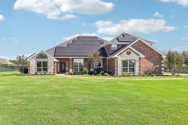 craftsman-style house featuring a front yard and solar panels