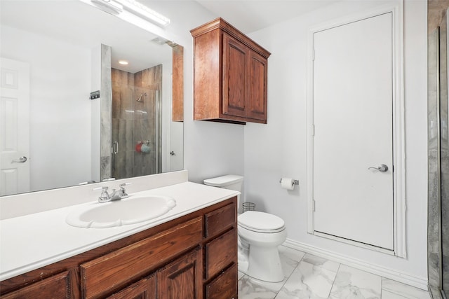 bathroom featuring an enclosed shower, vanity, and toilet