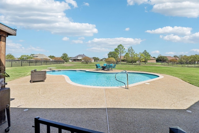 view of swimming pool with a diving board, a patio area, and a lawn