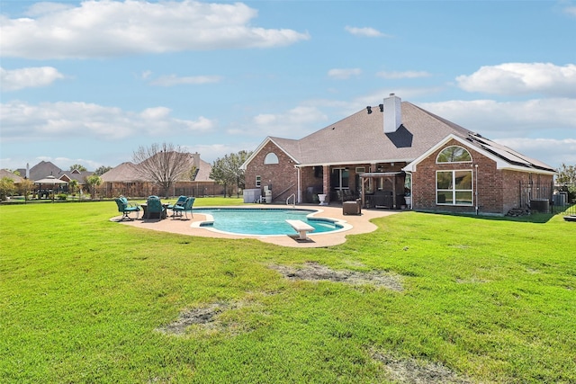 view of swimming pool with a patio area and a lawn