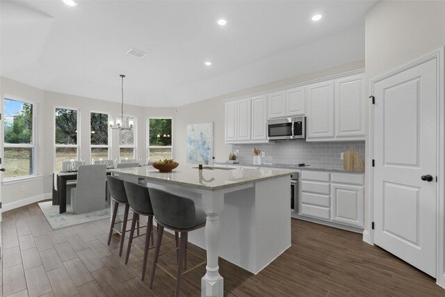 kitchen with white cabinetry, sink, an island with sink, and stainless steel appliances