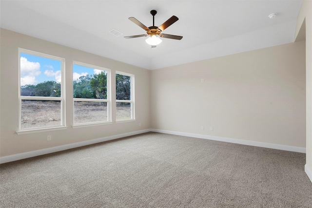 carpeted spare room featuring ceiling fan