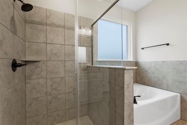 bathroom featuring separate shower and tub