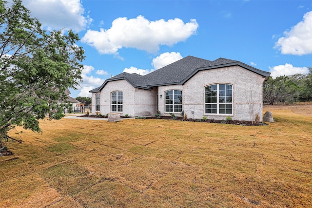 rear view of house featuring a yard