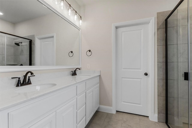 bathroom with tile patterned floors, vanity, and an enclosed shower